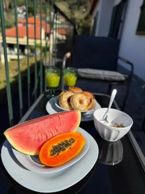 two plates of food on a table with watermelon at Casa Refúgio M in São Vicente