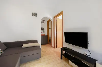 a living room with a flat screen tv on a wall at Casa Vitorino in Sagres