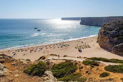 a group of people on a beach near the ocean at Casa Vitorino in Sagres