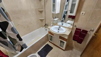 a bathroom with a sink and a tub and a toilet at Reis Magos View in Caniço