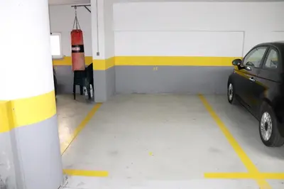 a car parked in a garage with a fire hydrant at Reis Magos View in Caniço