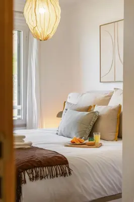 a bedroom with a bed with a tray of food on it at Apartamento Paz e Sossego - By Wehost in Panasqueira