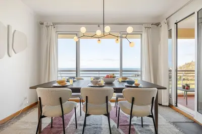 a dining room with a table and chairs with a view at Apartamento Paz e Sossego - By Wehost in Panasqueira