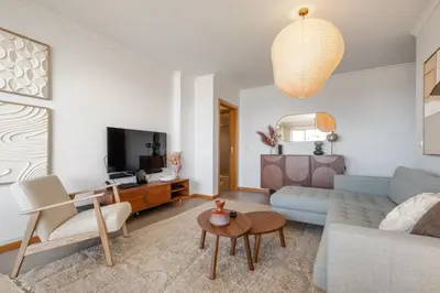 a living room with a couch and a table at Apartamento Paz e Sossego - By Wehost in Panasqueira