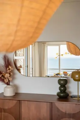 a mirror on a dresser in a room with a window at Apartamento Paz e Sossego - By Wehost in Panasqueira