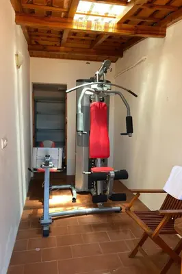 a room with a gym with a red chair at Holiday Home Ideales Familienhaus mit freiem Stadt- und Meerblick by Interhome in Funchal