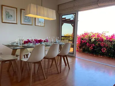 a dining room with a table and chairs with a view at Holiday Home Ideales Familienhaus mit freiem Stadt- und Meerblick by Interhome in Funchal