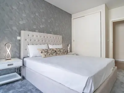 a bedroom with a large white bed and a wall at Apartment Movenpick Apartment by Interhome in Funchal