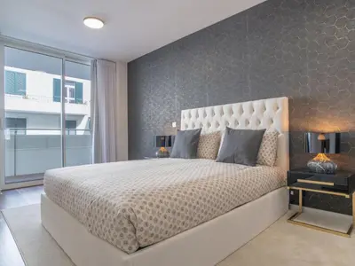 a bedroom with a large bed and a large window at Apartment Movenpick Apartment by Interhome in Funchal