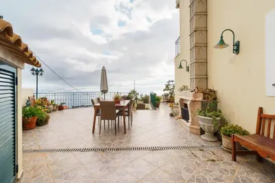 a patio with a table and chairs and a fireplace at GuestReady - Charming retreat in Funchal in Funchal