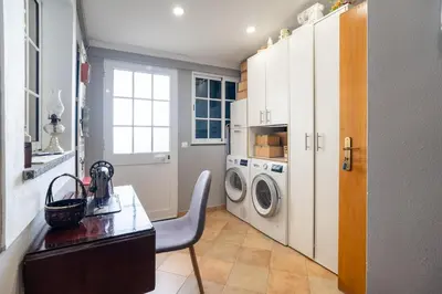 a kitchen with a table and a washing machine at GuestReady - Charming retreat in Funchal in Funchal