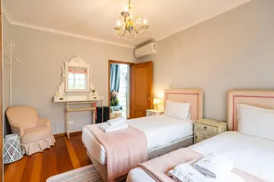 a bedroom with two beds and a chair and a fireplace at GuestReady - Charming retreat in Funchal in Funchal