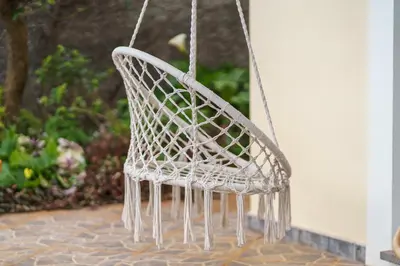 a white chair hanging from a porch at GuestReady - Charming retreat in Funchal in Funchal