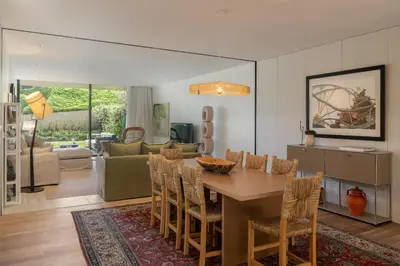 a dining room and living room with a table and chairs at Savoy Monumentalis XII Comfort with Pool in Funchal
