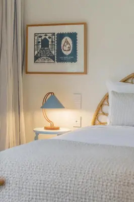a bedroom with a bed and a table with a lamp at Savoy Monumentalis XII Comfort with Pool in Funchal
