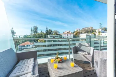 a balcony with a table and chairs on a balcony at Calas Loft by Atlantic Holiday in Funchal