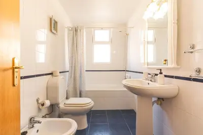 a bathroom with a toilet and a sink and a tub at Sunrising Apartment by Atlantic Holiday in Caniço