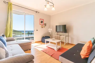 a living room with a couch and a tv at Sunrising Apartment by Atlantic Holiday in Caniço