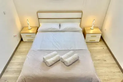 a bedroom with a bed with two towels on it at Yara House in Câmara de Lobos
