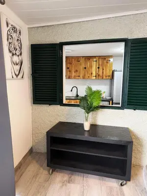 a black coffee table with a plant on top of it at Yara House in Câmara de Lobos