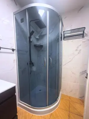 a shower with a glass door in a bathroom at Yara House in Câmara de Lobos