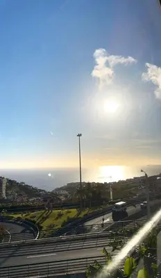 a view of a highway with the sun in the sky at Yara House in Câmara de Lobos