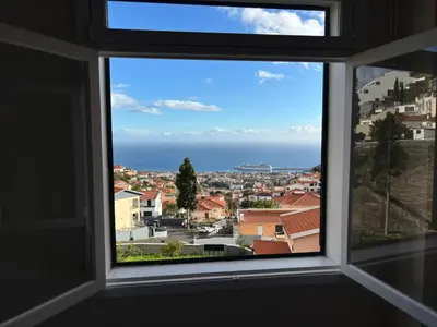 a kitchen with white cabinets and a sink at Santos Living Rentals in Funchal
