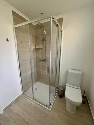 a shower stall in a bathroom with a toilet at Santos Living Rentals in Funchal