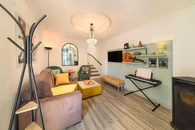 a living room with a couch and a keyboard at Melody House of Ponta do Sol in Canhas