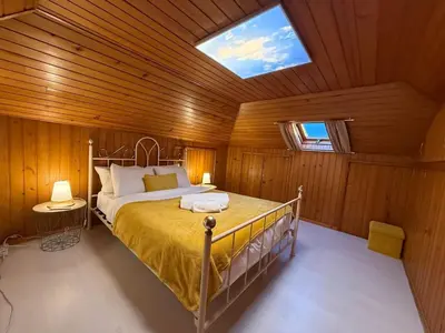a bedroom with a bed in a wooden ceiling at Melody House of Ponta do Sol in Canhas