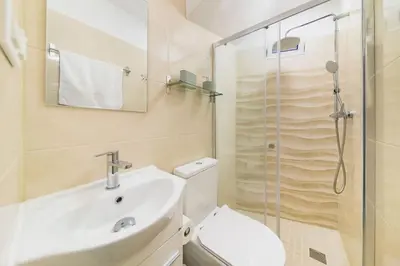 a bathroom with a toilet and a sink and a shower at Melody House of Ponta do Sol in Canhas