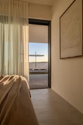 a living room with white furniture and large windows at Moradia Exclusiva V3 com Piscina Privada e Vista Mar- Salema in Salema