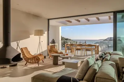 a white living room with a couch and a table at Moradia Exclusiva V3 com Piscina Privada e Vista Mar- Salema in Salema