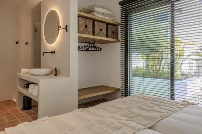 a dining room with a large wooden table and chairs at Exclusive Luxury Villa Pool & Ocean View Salema in Budens