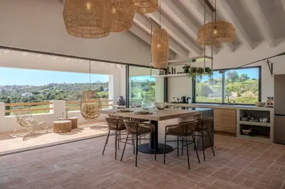 a living room with a couch and a table at Exclusive Luxury Villa Pool & Ocean View Salema in Budens