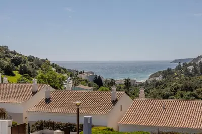 a kitchen with a counter with a fireplace in it at Exclusive Luxury Villa Pool & Ocean View Salema in Budens