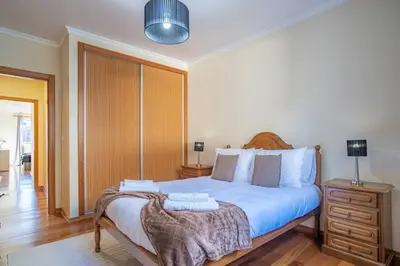 a bedroom with a large bed with two towels on it at Vista Calheta Apartment in Calheta