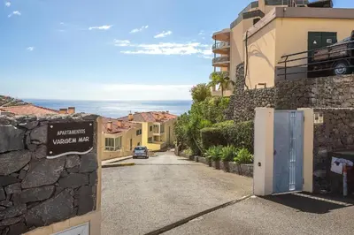 a street in a town with a sign on a wall at Vista Calheta Apartment in Calheta