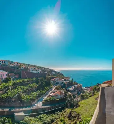 a view of the ocean with the sun in the sky at Vista Calheta Apartment in Calheta