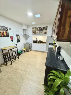 a kitchen with a counter and a table in a room at Ocean View Guest House in São Vicente