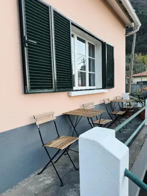 a group of tables and chairs in front of a building at Ocean View Guest House in São Vicente