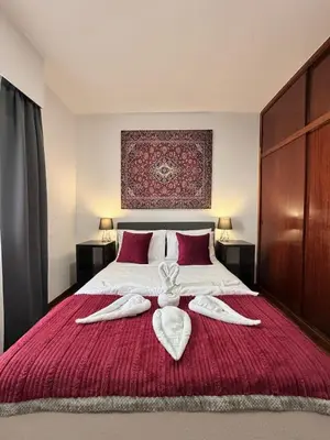 a bedroom with a bed with two towels on it at Ocean View Guest House in São Vicente
