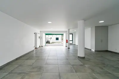 an empty hallway with white walls and tile floors at Garajau Lovers Retreat House 3BR by Wanderlust Madeira in Caniço