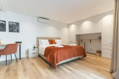 a bedroom with a bed and a desk and a table at Breeze House 2 by AH in Caniço