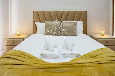 a bedroom with a bed with towels on it at Villa Golden by Escape to Madeira in Machico