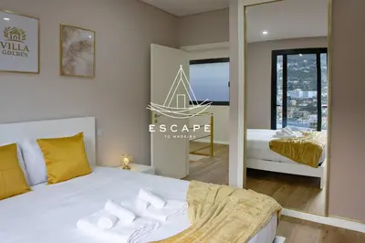 a bedroom with a bed and a mirror at Villa Golden by Escape to Madeira in Machico