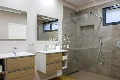 a bathroom with two sinks and a shower at Villa Golden by Escape to Madeira in Machico