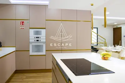 a kitchen with a island with a sail on the wall at Villa Golden by Escape to Madeira in Machico