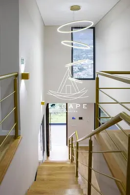 a hallway with stairs and a chandelier at Villa Golden by Escape to Madeira in Machico