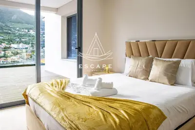 a bedroom with a large bed with a gold blanket at Villa Golden by Escape to Madeira in Machico